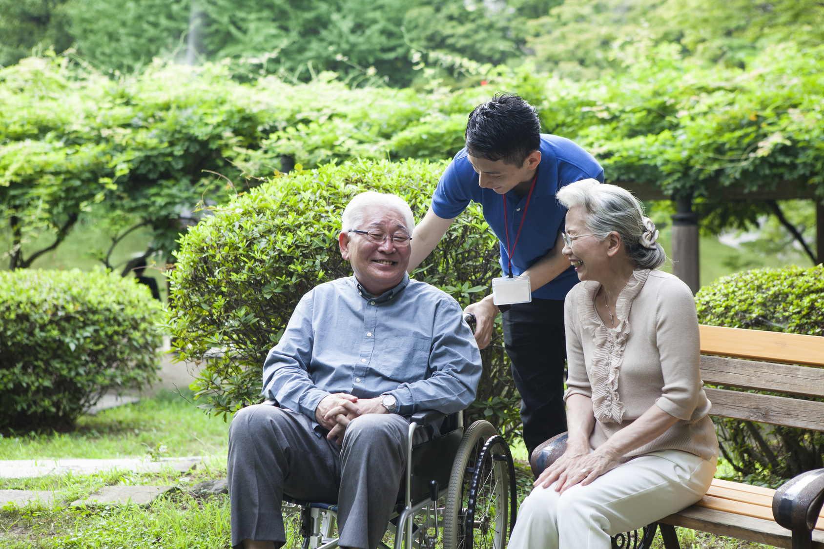 An old couple talks with care workers happily